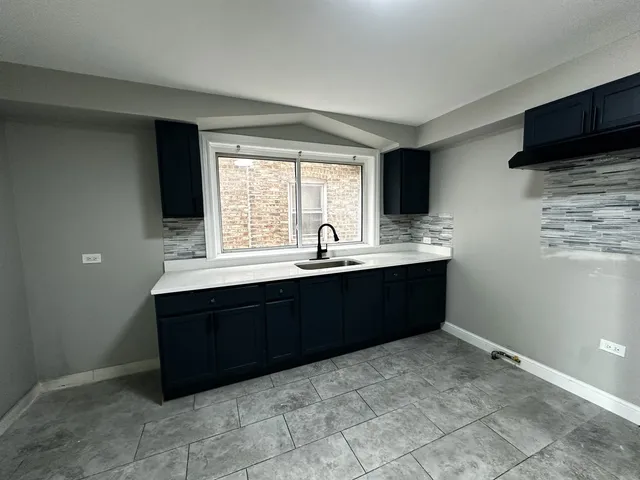 a kitchen with a sink and a window