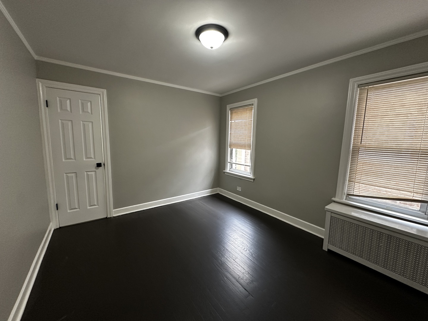 6549 South Keeler Avenue Chicago, IL 60629 - Photo 4 of 16 an empty room with wooden floor and windows