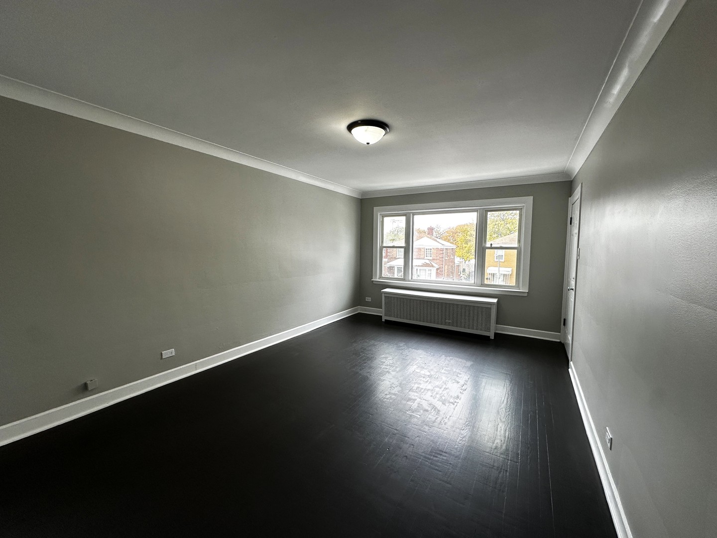6549 South Keeler Avenue Chicago, IL 60629 - Photo 5 of 16 an empty room with wooden floor and windows