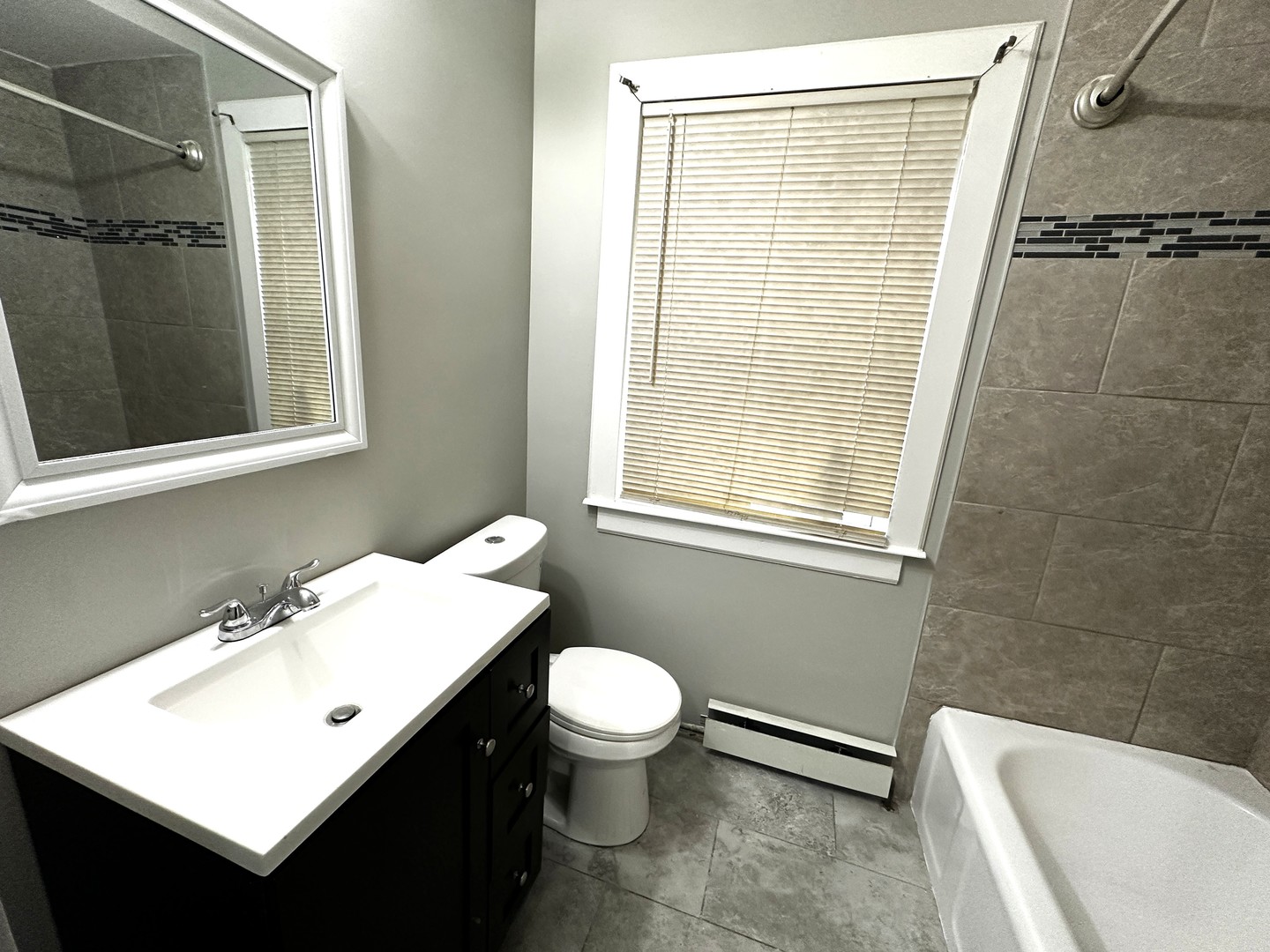 6549 South Keeler Avenue Chicago, IL 60629 - Photo 7 of 16 a bathroom with a sink a toilet and shower