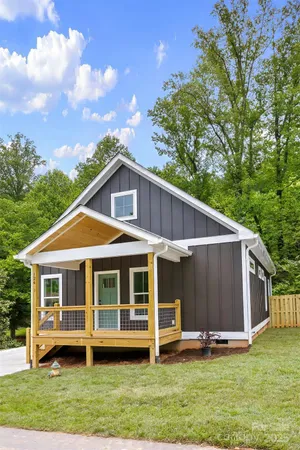 a view of a house with a yard balcony and sitting area