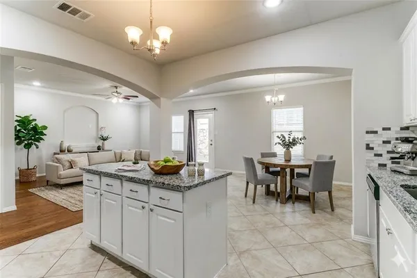 a view of a dining room with furniture and chandelier