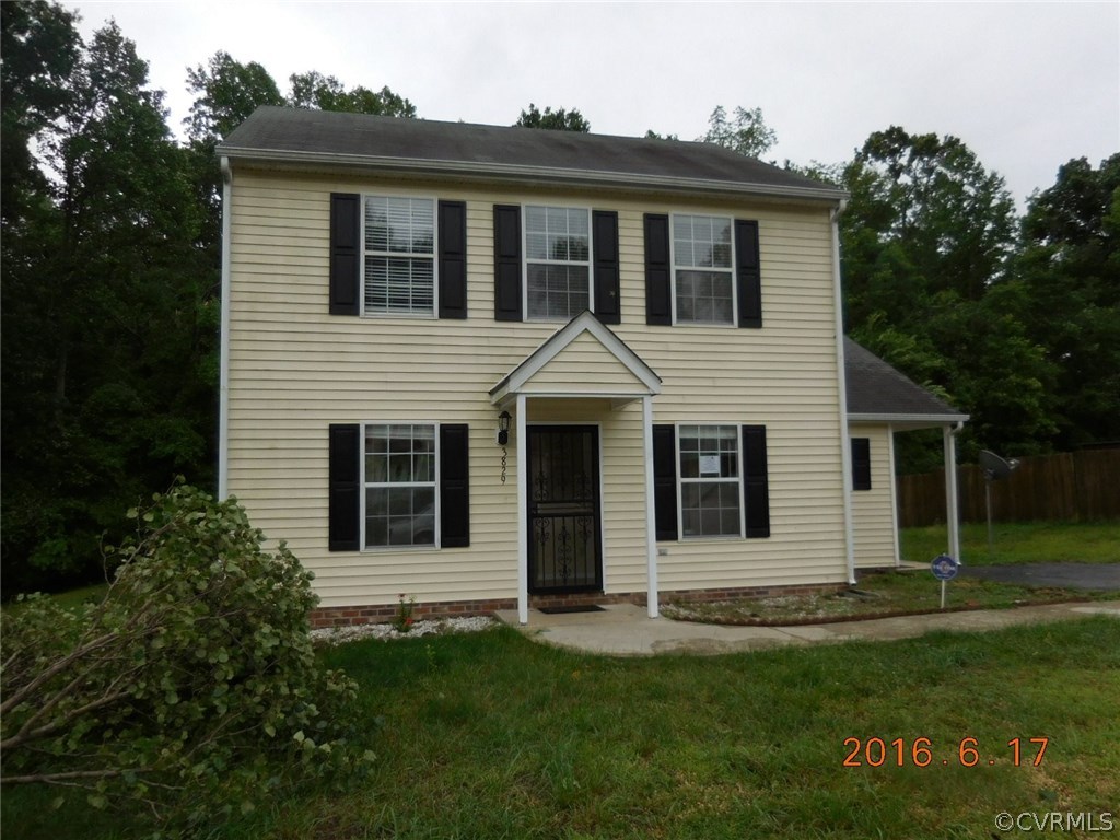 3829 Goodell Road Richmond, VA 23223 - Photo 1 of 11 a front view of a house with a garden