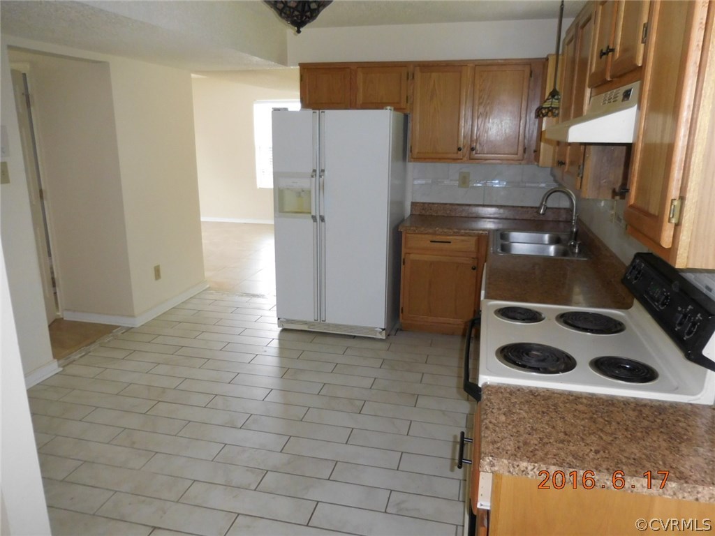 3829 Goodell Road Richmond, VA 23223 - Photo 3 of 11 a kitchen with a refrigerator and a stove