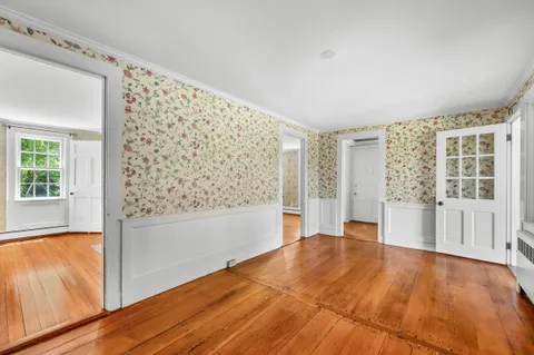 a kitchen with granite countertop a sink a stove cabinets and wooden floor