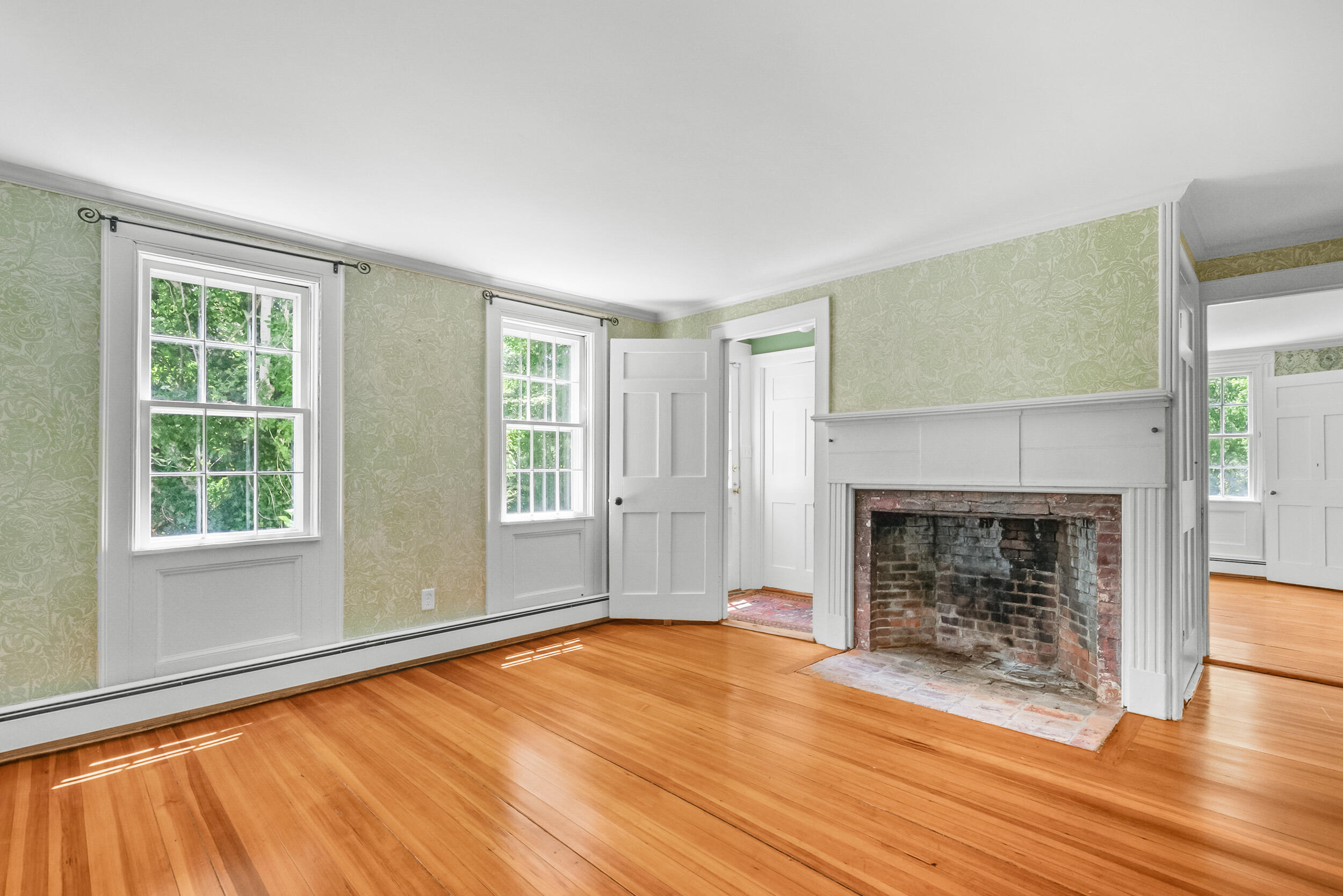 56 Wharf Lane Yarmouth Port, MA 02675 - Photo 18 of 71 wooden floor fireplace and windows in an empty room