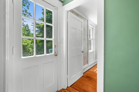 a view of a room that has a large window and a potted plant