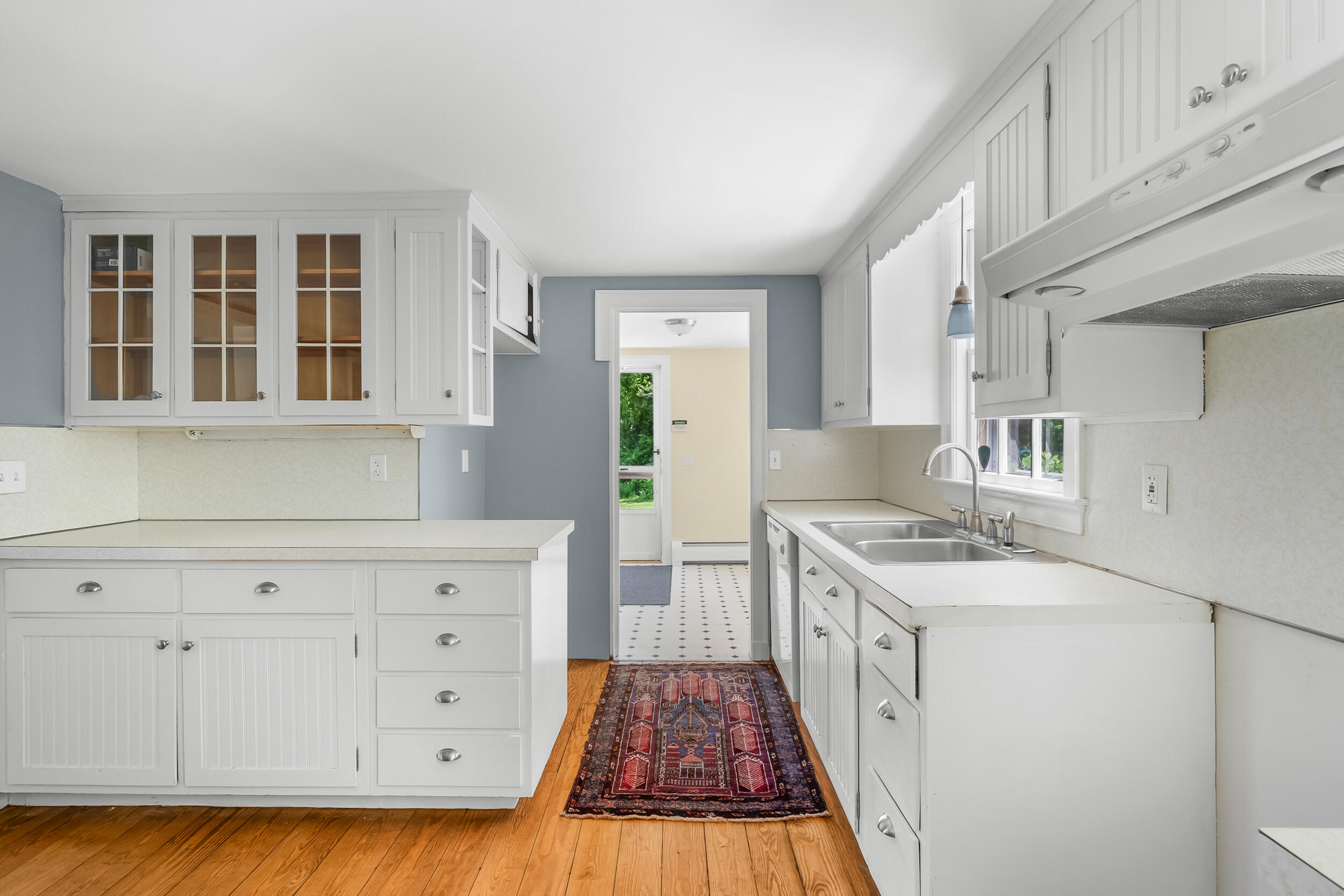 56 Wharf Lane Yarmouth Port, MA 02675 - Photo 22 of 71 a kitchen with granite countertop a sink a stove cabinets and wooden floor