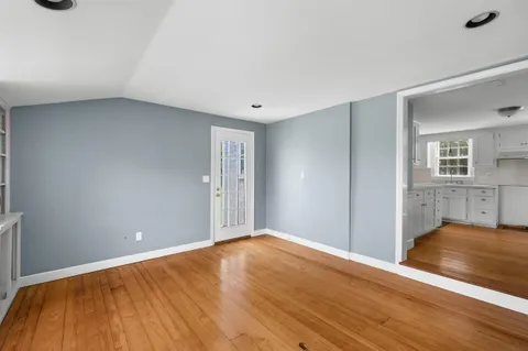 a view of an empty room with wooden floor