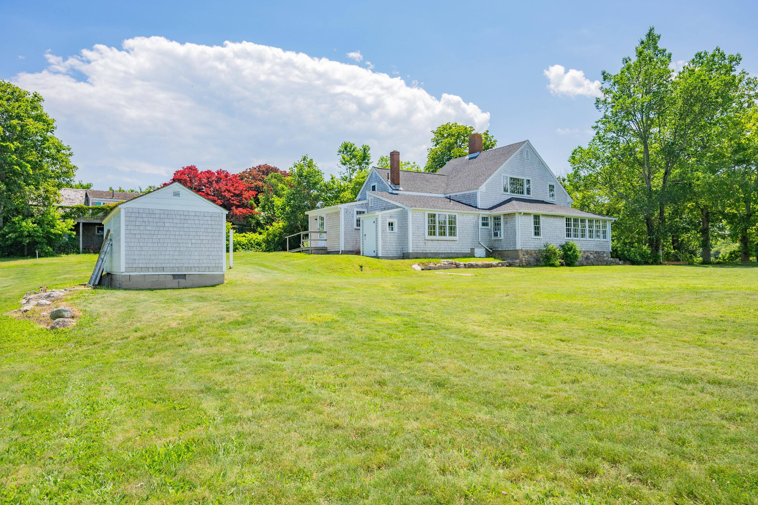 56 Wharf Lane Yarmouth Port, MA 02675 - Photo 3 of 71 a front view of a house with a garden and yard