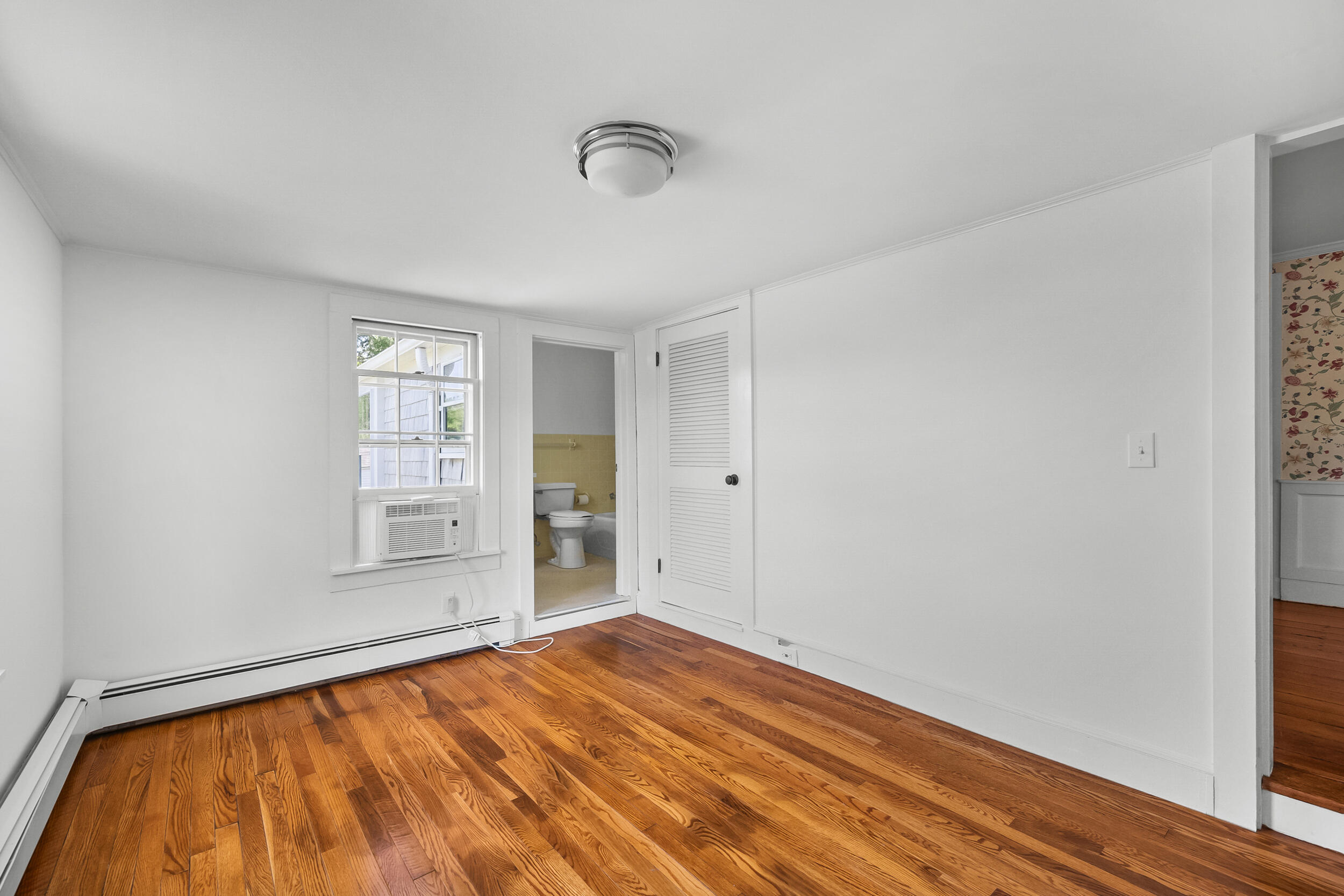 56 Wharf Lane Yarmouth Port, MA 02675 - Photo 35 of 71 a view of empty room with wooden floor and fan