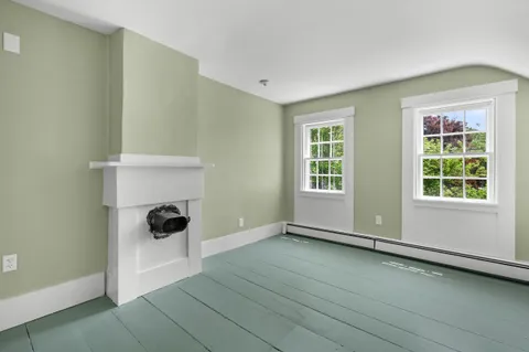 a view of a house with a big yard and potted plants