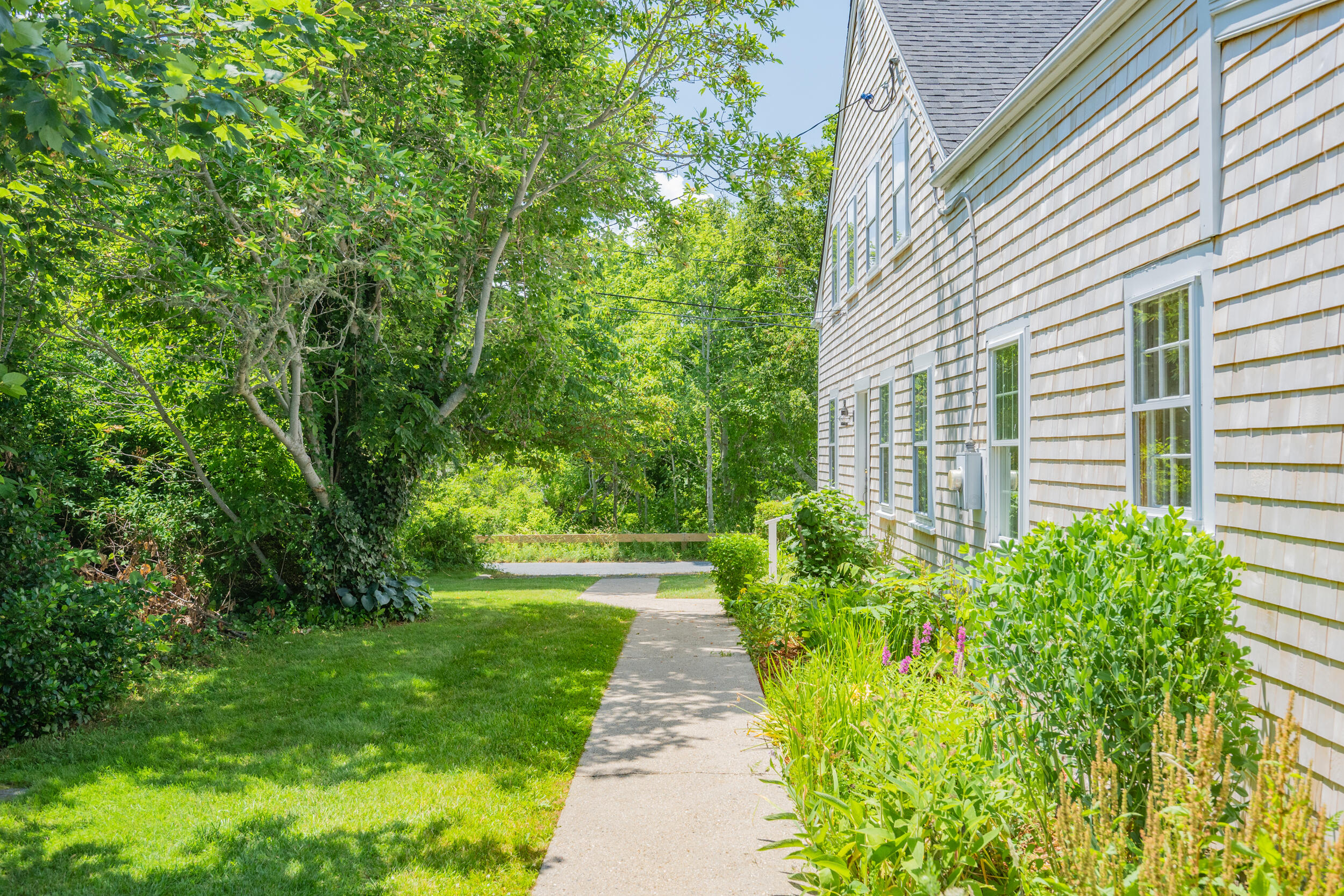 56 Wharf Lane Yarmouth Port, MA 02675 - Photo 53 of 71 a front view of a house with a garden