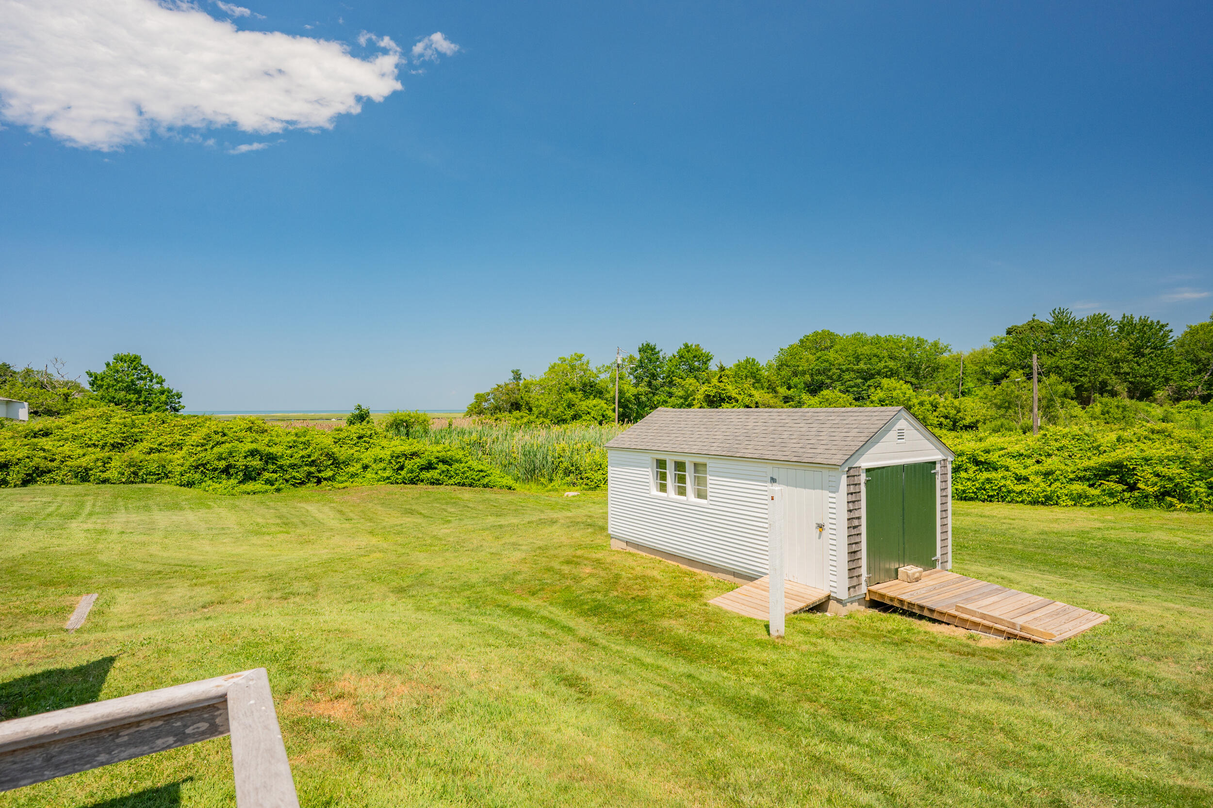 56 Wharf Lane Yarmouth Port, MA 02675 - Photo 54 of 71 a view of a yard with a house