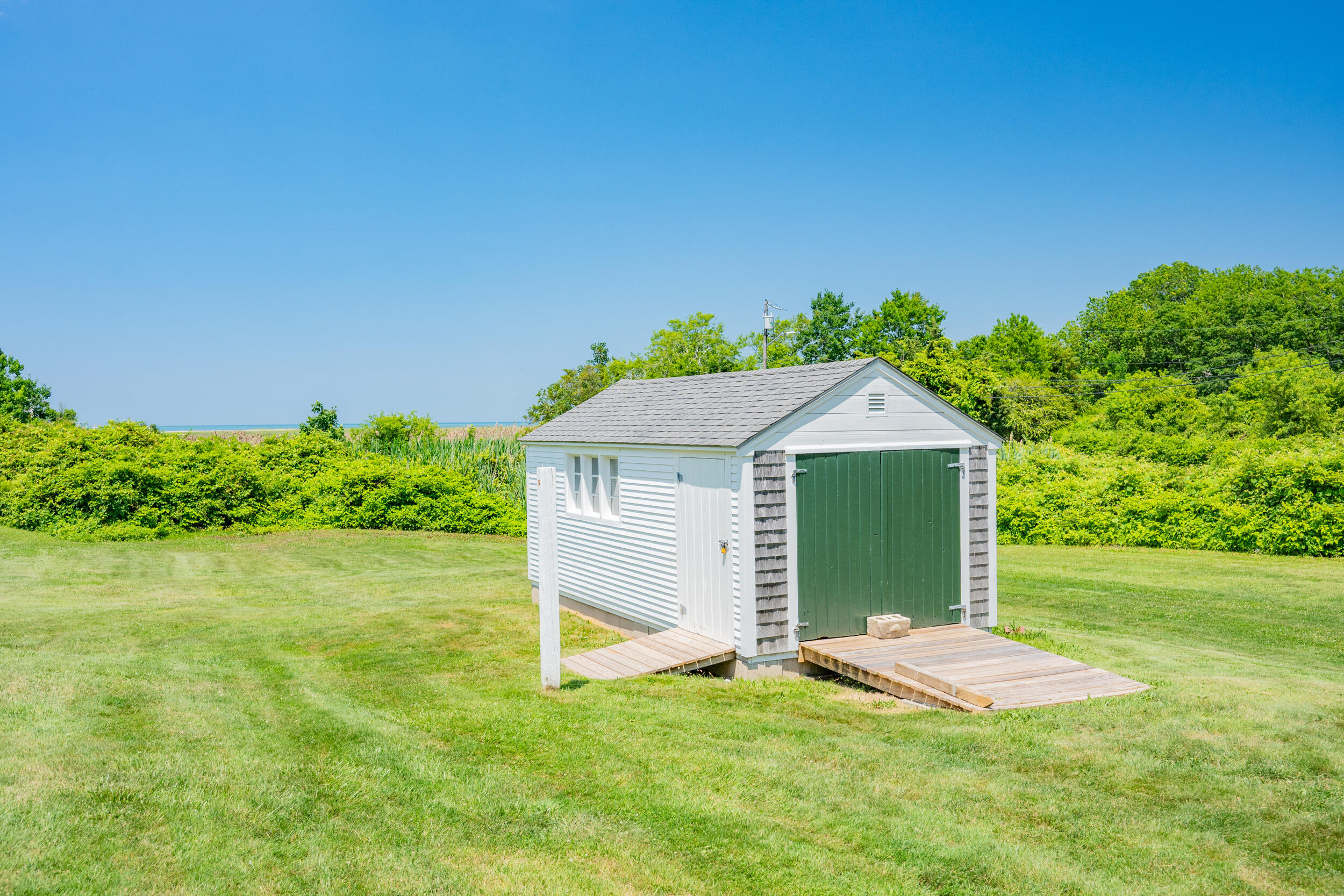 56 Wharf Lane Yarmouth Port, MA 02675 - Photo 56 of 71 a view of a backyard with plants and large trees