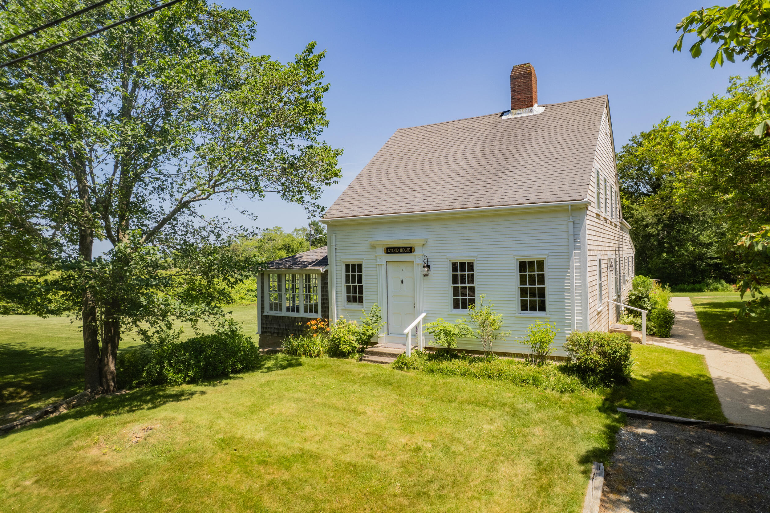 56 Wharf Lane Yarmouth Port, MA 02675 - Photo 65 of 71 a front view of house with yard and trees around