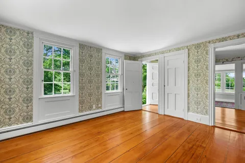 a view of wooden floor and windows in a room