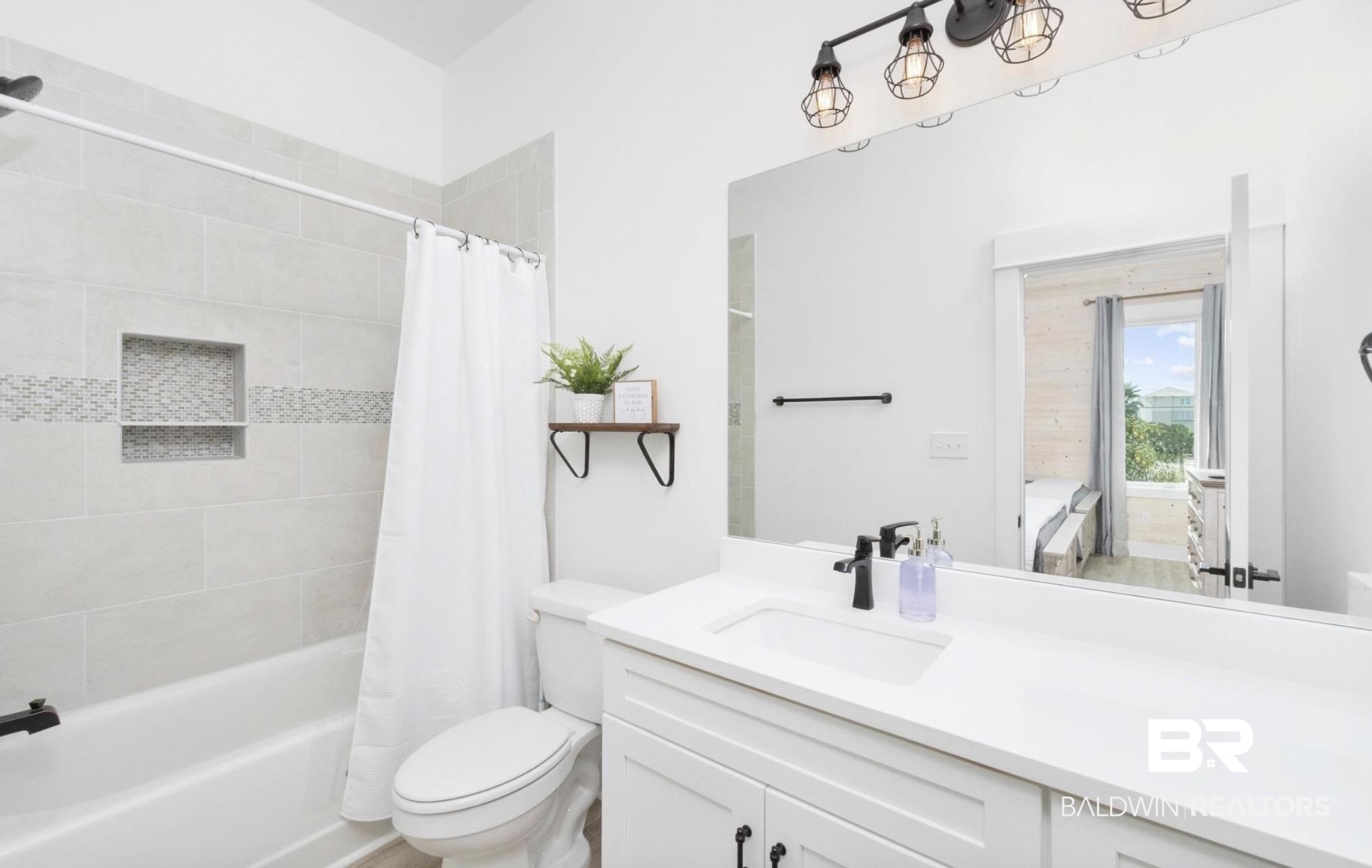 20 West Gate Orange Beach, AL 36561 - Photo 13 of 15 Full bath featuring shower / bath combination with curtain and vanity