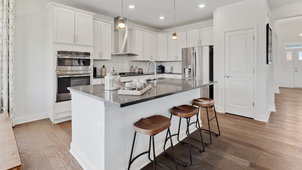 16228 Longcommon Lane Plainfield, IL 60586 - Photo 3 of 21 a kitchen with stainless steel appliances granite countertop a refrigerator a stove a sink and white cabinets with wooden floor