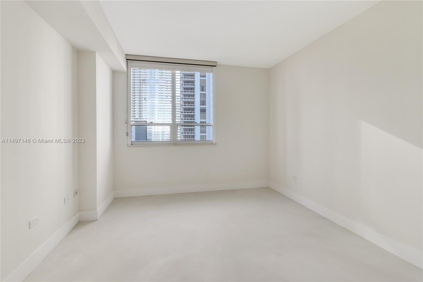 801 Brickell Key Boulevard, Unit 1102 Miami, FL 33131 - Photo 14 of 15 an empty room with a window