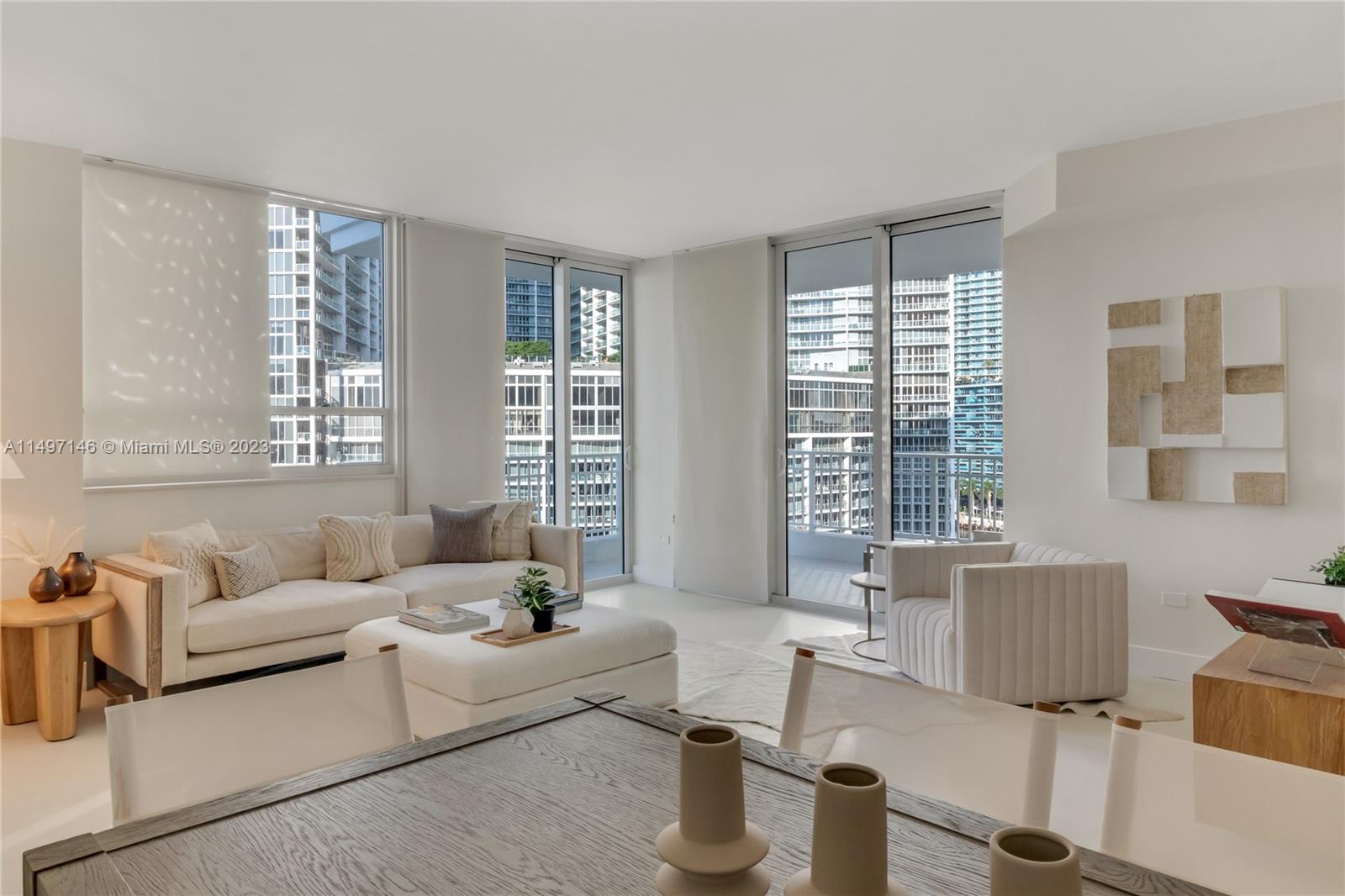 801 Brickell Key Boulevard, Unit 1102 Miami, FL 33131 - Photo 3 of 15 a living room with furniture and floor to ceiling windows
