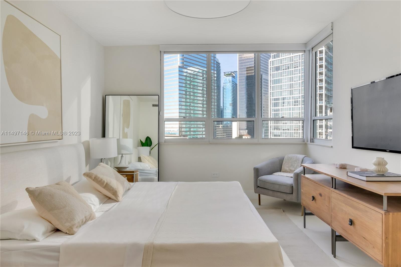 801 Brickell Key Boulevard, Unit 1102 Miami, FL 33131 - Photo 7 of 15 a bedroom with a bed and a flat screen tv
