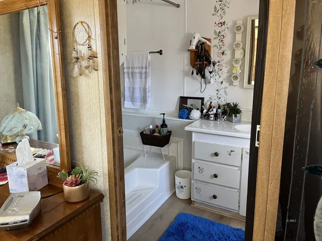 a bedroom with a bed and a flat tv screen