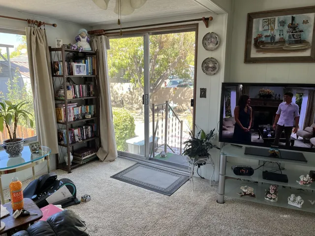 a room with lots of books and a large window