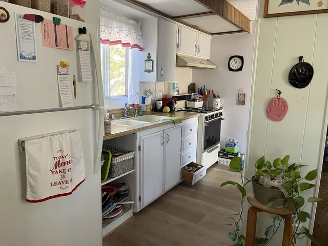 a kitchen with a refrigerator and a table