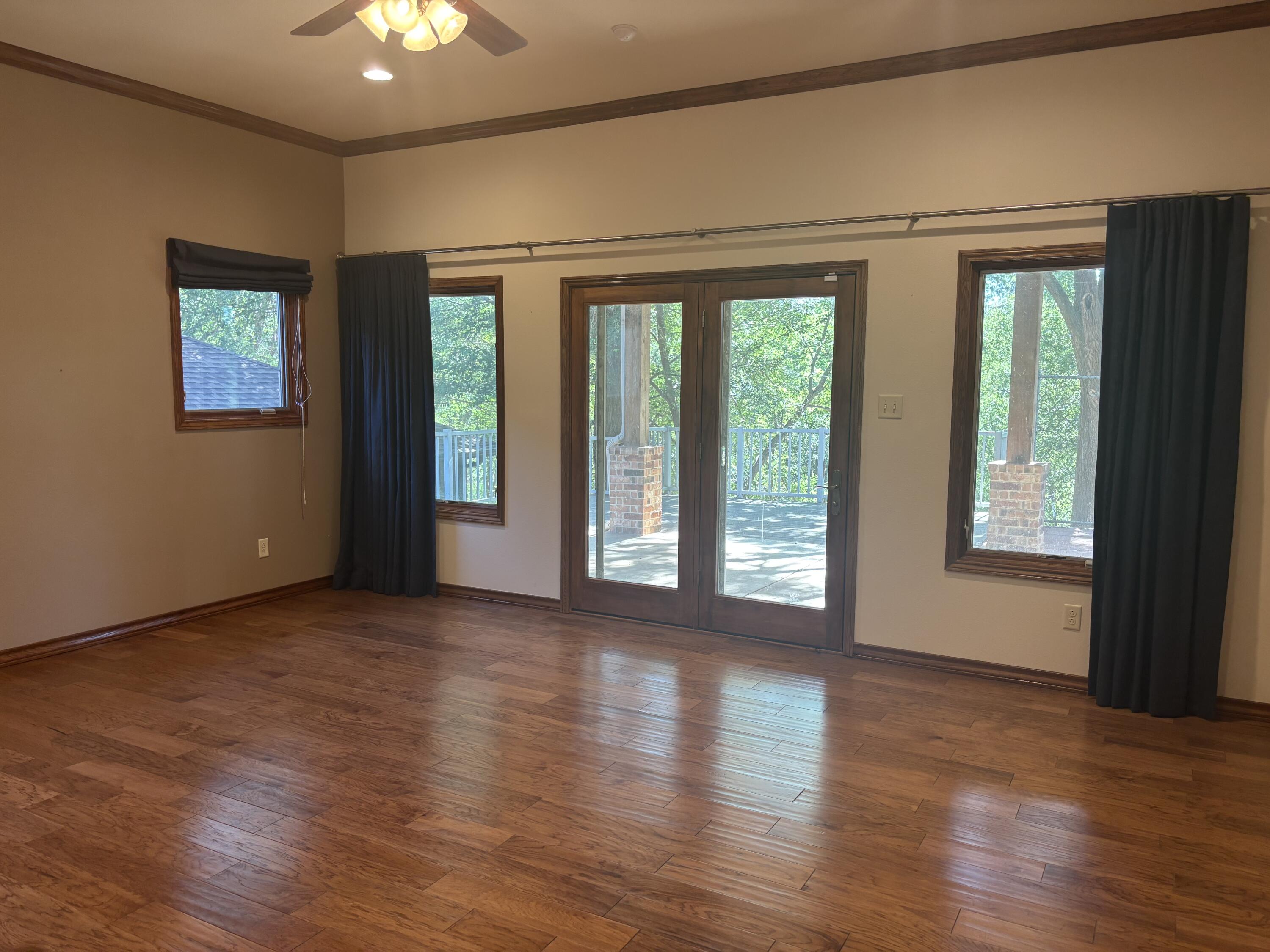 33 West Lakeshore Drive Ransom Canyon, TX 79366 - Photo 27 of 48 a view of an empty room with wooden floor and a window