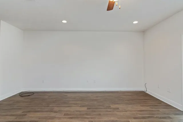 a view of an empty room and wooden floor