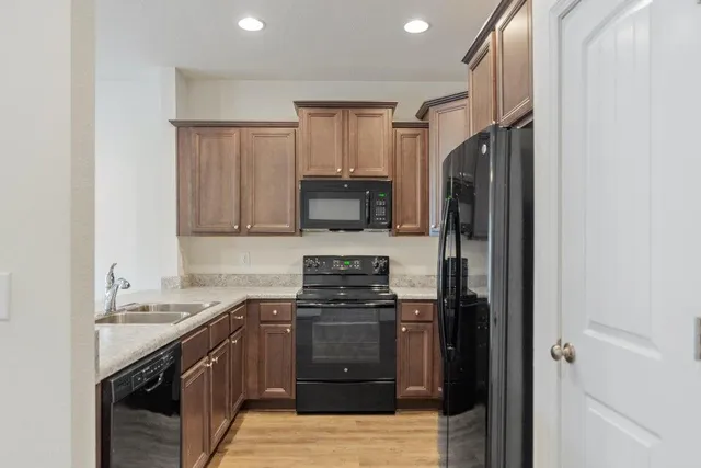 a kitchen with a sink stove and refrigerator