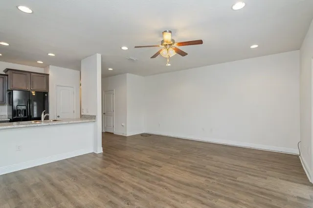 a view of a kitchen with a sink and a refrigerator