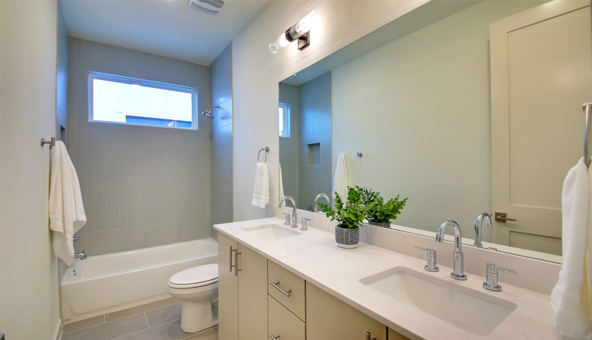 6802 Montana Street, Unit 2 Austin, TX 78741 - Photo 10 of 13 A sleek vanity with dual sinks creates a contemporary feel in this well-appointed bathroom.
