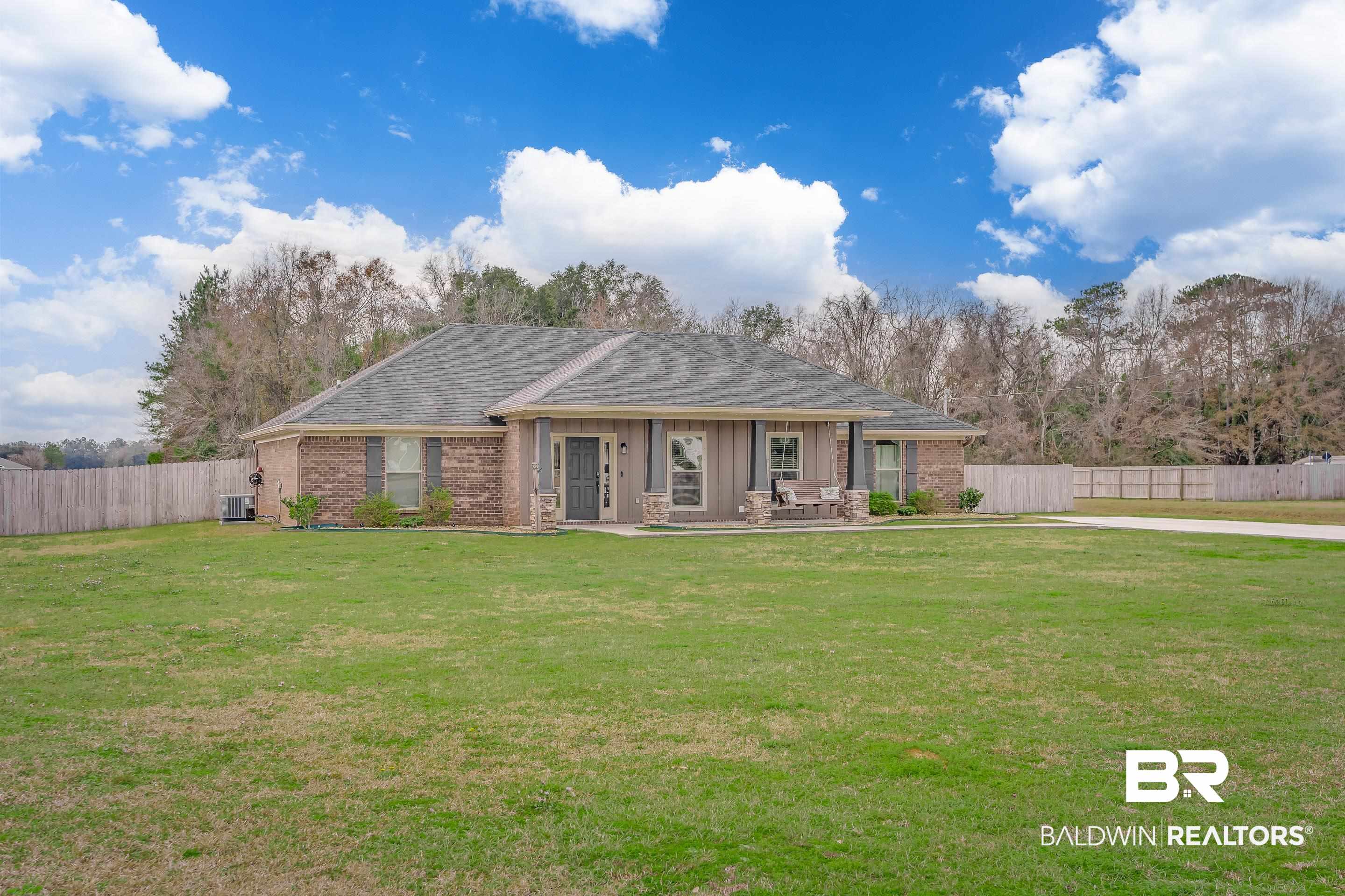 13235 Tom Gaston Road Mobile, AL 36695 - Photo 35 of 43 View of front of property with a porch, a front yard, and central AC unit