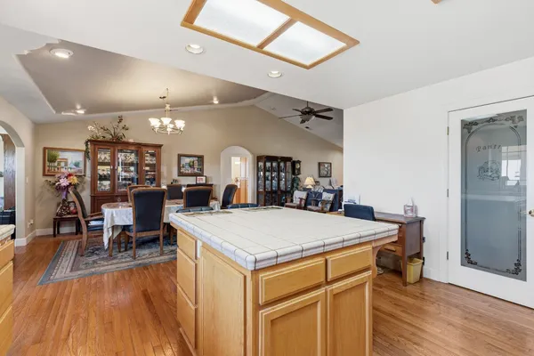 a large kitchen with a table and chairs
