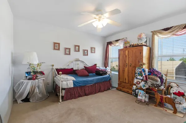 a bedroom with bed and a window