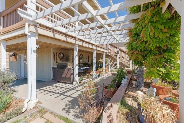 a view of a house with a patio and wooden fence