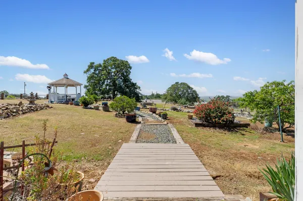 a front view of a house with lake view and a garden