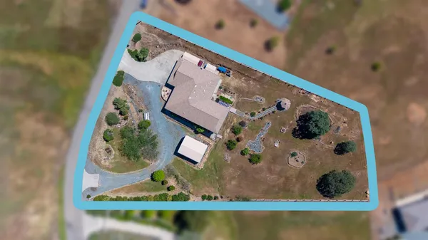 an aerial view of a house with a swimming pool