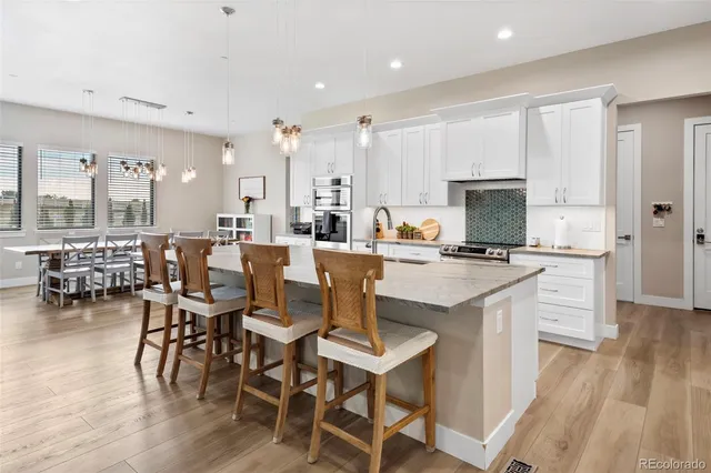 a large kitchen with a table and chairs