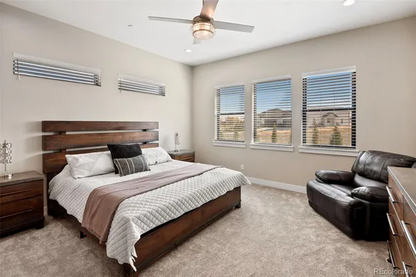 a bedroom with bed couch and window