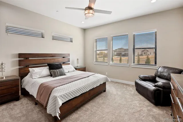 a bedroom with bed couch and window