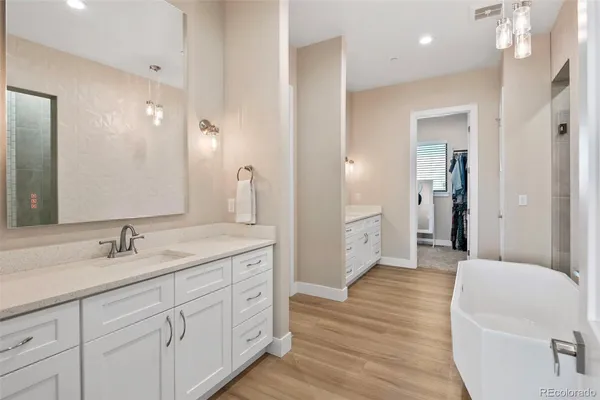 a spacious bathroom with a granite countertop sink a mirror and a toilet