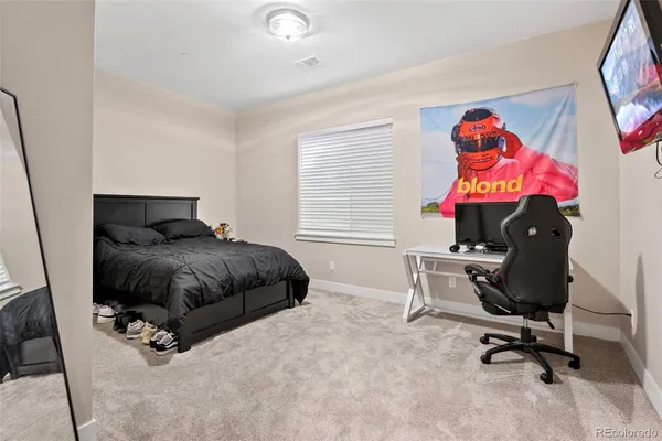 a bedroom with a bed and a bookshelf