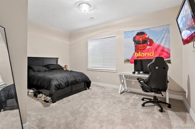 a bedroom with a bed and a bookshelf