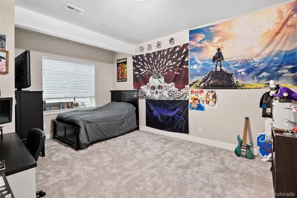 a bedroom with a bed and a couch