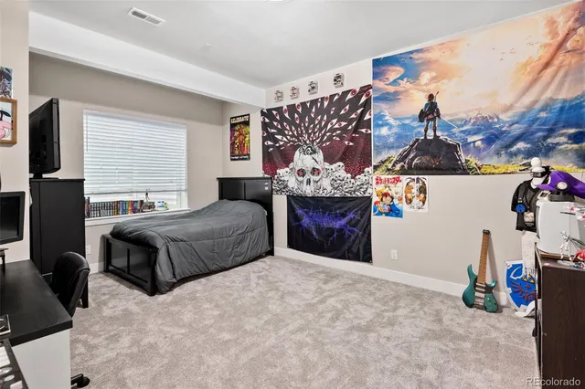 a bedroom with a bed and a couch