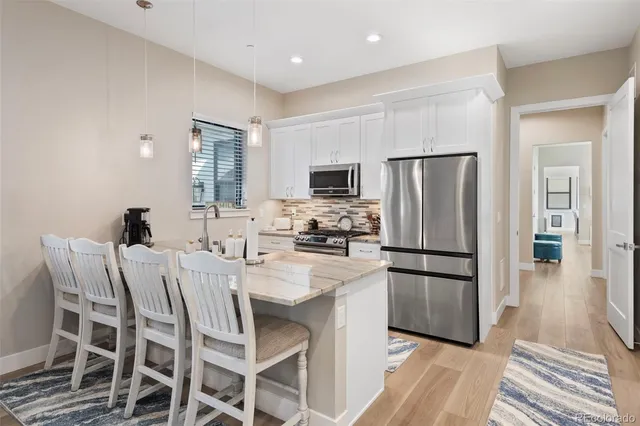 a kitchen with stainless steel appliances a refrigerator stove microwave and cabinets