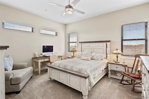 a spacious bedroom with a bed and a couch